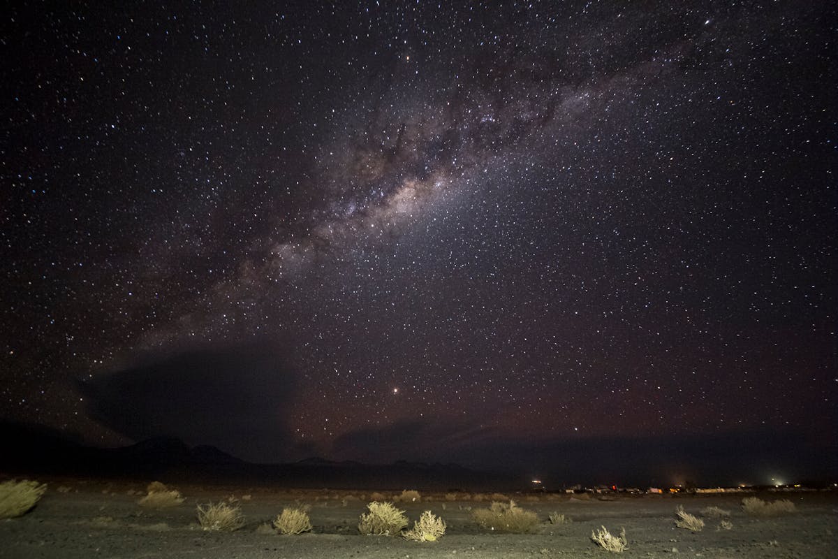 The Milky Way stretching across the night sky above the Atacama Desert landscape