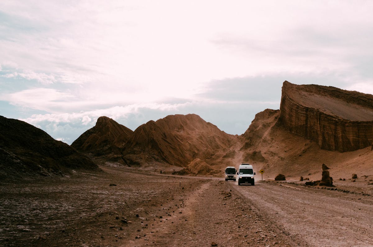Rugged mountains and dirt road in Valle de la Luna at sunset in the Atacama Desert