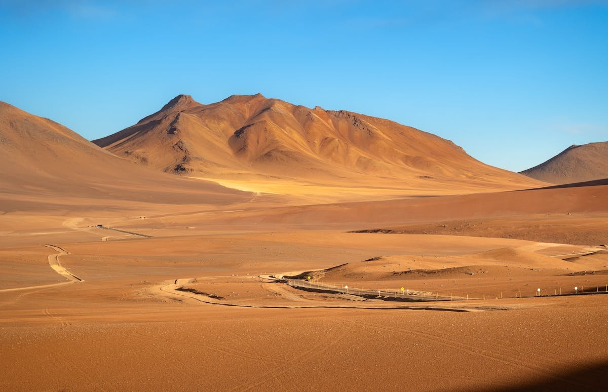 Dramatic sunset over the Atacama Desert dunes and mountains in Chile