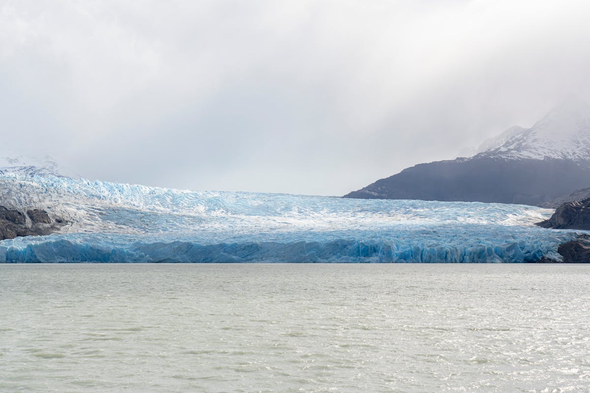 Grey Glacier surrounded by mountains and lake in Torres del Paine, Chile