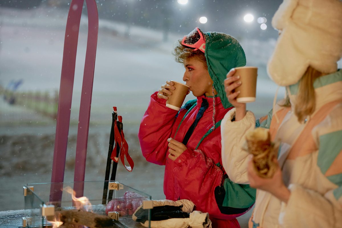 People enjoying winter drinks at a ski resort at night