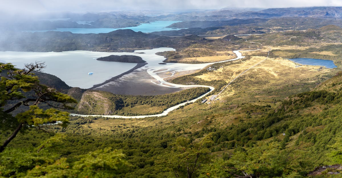 Aerial view of the majestic Torres del Paine landscape showing rivers, forests and mountain peaks