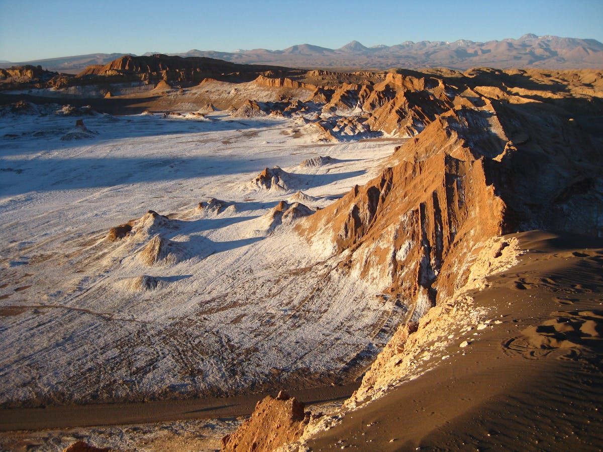 Valley of the Moon in San Pedro de Atacama Chile during sunset with dramatic rock formations and warm light