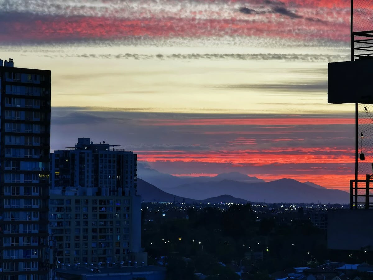 Sunset view over Santiago cityscape with colorful skies and silhouetted buildings