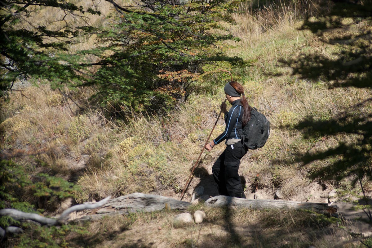 Woman trekking on trail in El Chalten Patagonia surrounded by mountains and nature