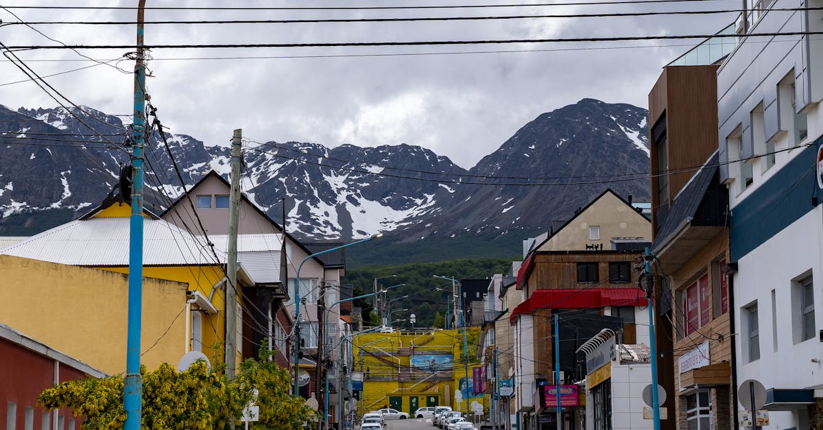 Colorful buildings along a Patagonian town street with dramatic sky