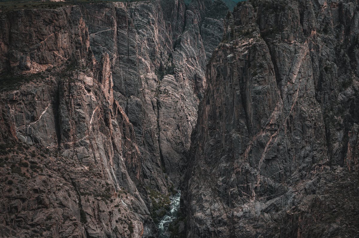 Dramatic rocky canyon with river flowing through mountain landscape