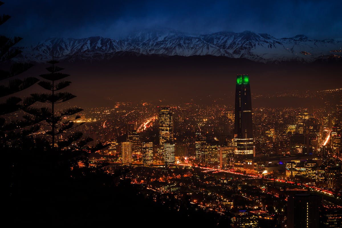 Night view of Santiago skyline with city lights and the Andes mountains in the background