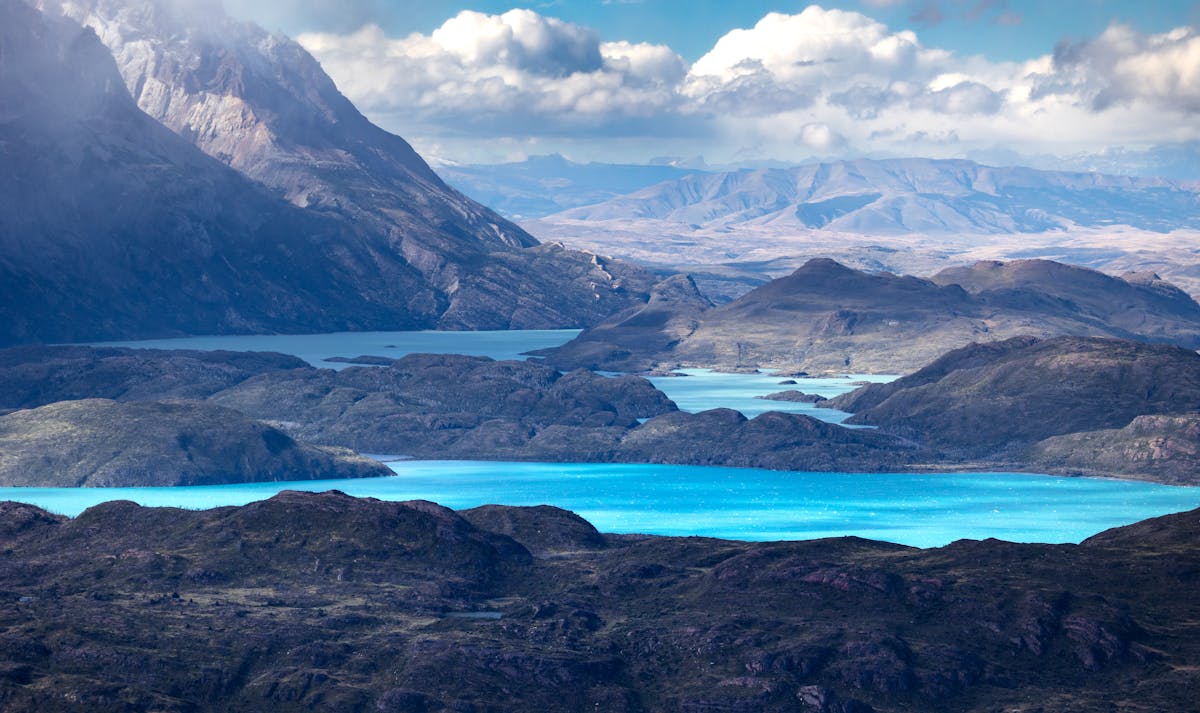 Torres del Paine with turquoise lakes and rugged mountains under cloudy sky